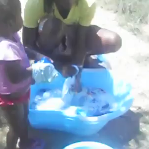 Father Washing His Kids Clothes