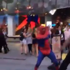 Man attacks a spider man street performer